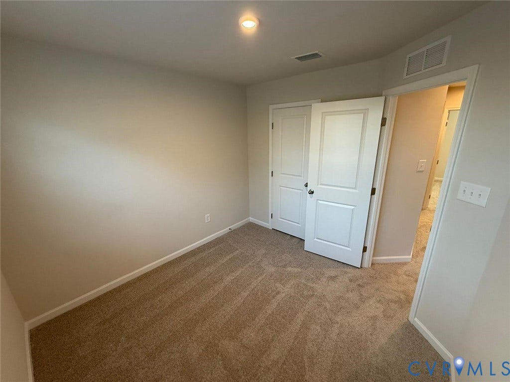 5409 Canterbury Ridge Way, Richmond, VA 23224 Neutral tone wall paint, recessed ceiling lighting, textured carpet flooring, white trim, and a bi-fold closet door