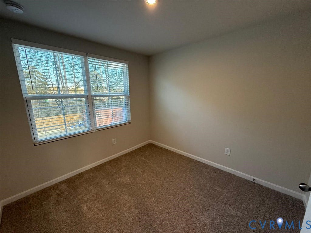 5409 Canterbury Ridge Way, Richmond, VA 23224 Plush carpeting, neutral wall tones, and overhead lighting