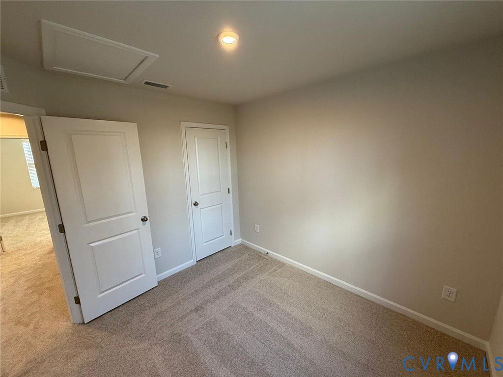 5409 Canterbury Ridge Way, Richmond, VA 23224 Plush carpet flooring, neutral painted walls, white paneled doors, and a ceiling-mounted light fixture