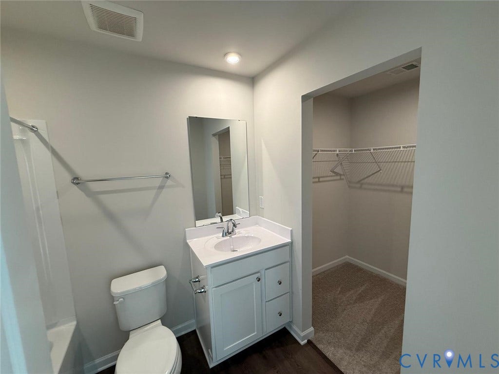 5409 Canterbury Ridge Way, Richmond, VA 23224 White vanity with a quartz-finish countertop and undermount sink