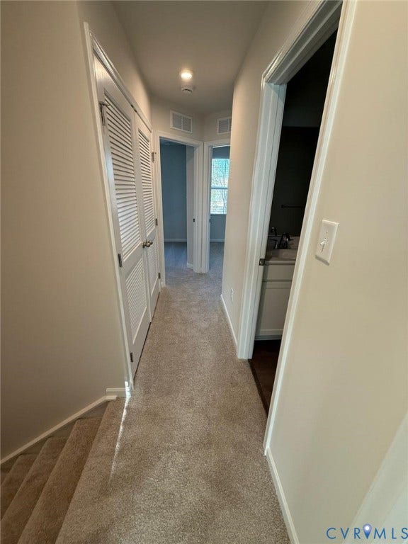 5409 Canterbury Ridge Way, Richmond, VA 23224 Carpeted hallway with painted walls, recessed lighting, and white louvered closet doors