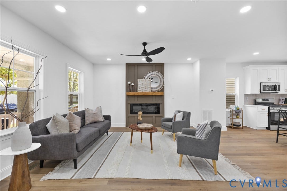 Open-concept living area featuring wood-finish flooring, recessed lighting, and a modern ceiling fan
