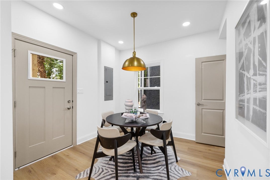 Recessed lighting, wood-finish flooring, and a contemporary gold pendant light