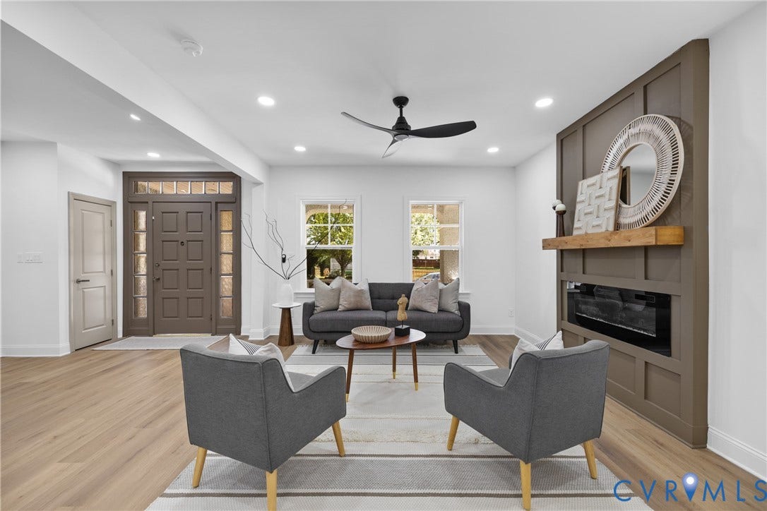 Open-concept living area featuring wood-finish flooring, recessed lighting, and a modern ceiling fan