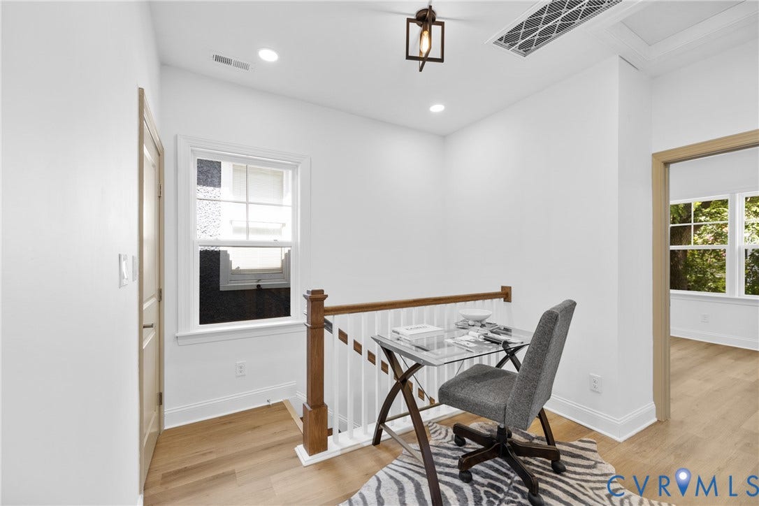 Wood-finish flooring, white walls, and a window with natural light
