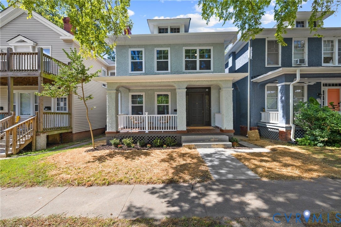 Two-story residence with a light blue facade and white trim