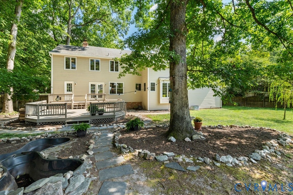 2416 Mountainbrook Drive, Crown Grant, Henrico, VA 23233 Multi-level wood deck, stone pathway, mature trees, landscaped planting beds, and a grassy lawn