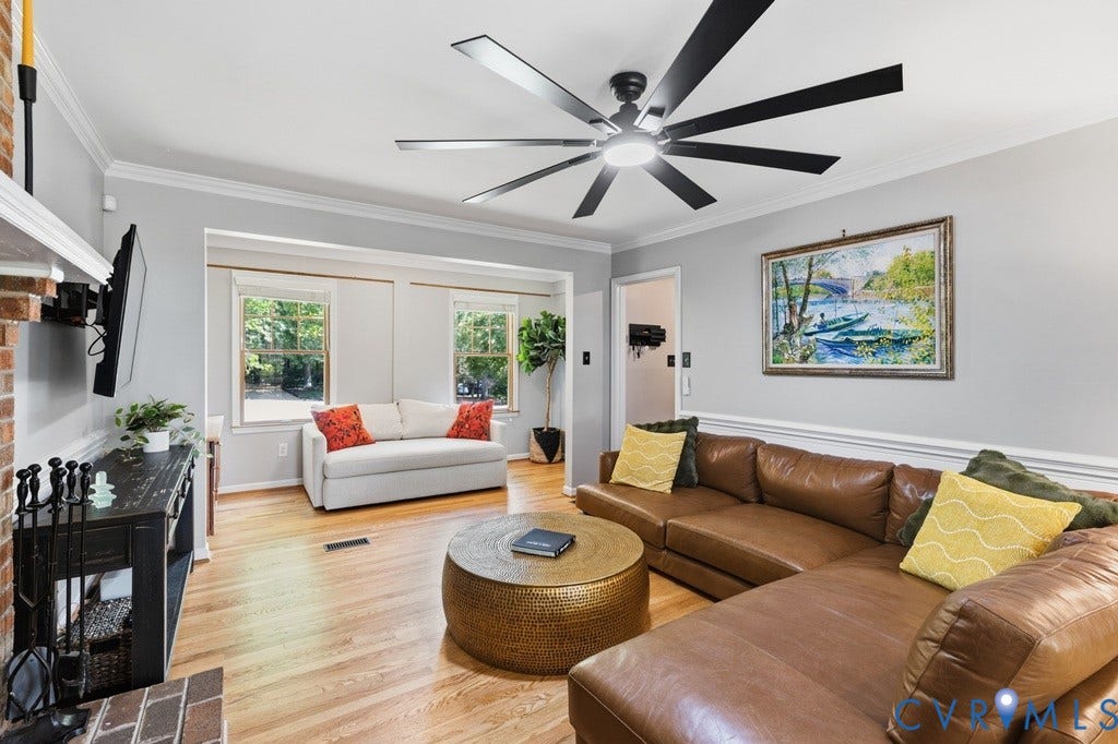 2416 Mountainbrook Drive, Crown Grant, Henrico, VA 23233 Hardwood flooring, brick fireplace surround, crown molding, and a modern ceiling fan