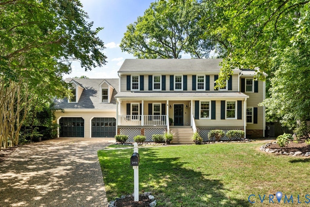 2416 Mountainbrook Drive, Crown Grant, Henrico, VA 23233 Two-story residence featuring dormer windows, a covered front porch with white railings, and a two-car garage with carriage-style doors