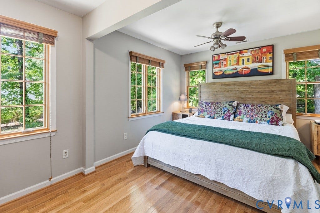 2416 Mountainbrook Drive, Crown Grant, Henrico, VA 23233 Hardwood flooring, multiple grid-pattern windows, light gray wall finishes, recessed ceiling beam, and a ceiling fan with integrated lighting