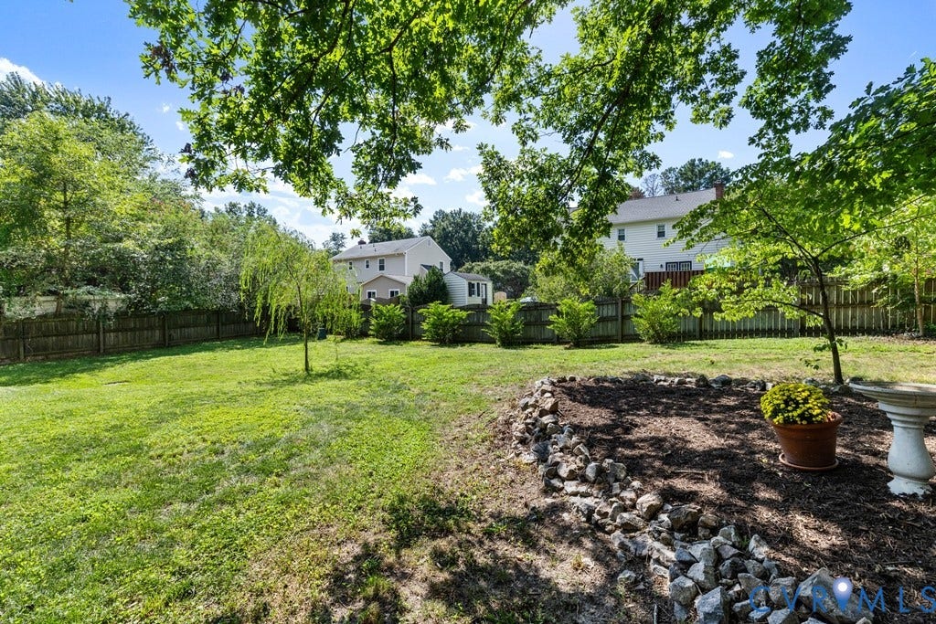 2416 Mountainbrook Drive, Crown Grant, Henrico, VA 23233 Expansive lawn area with mature trees and a wood privacy fence