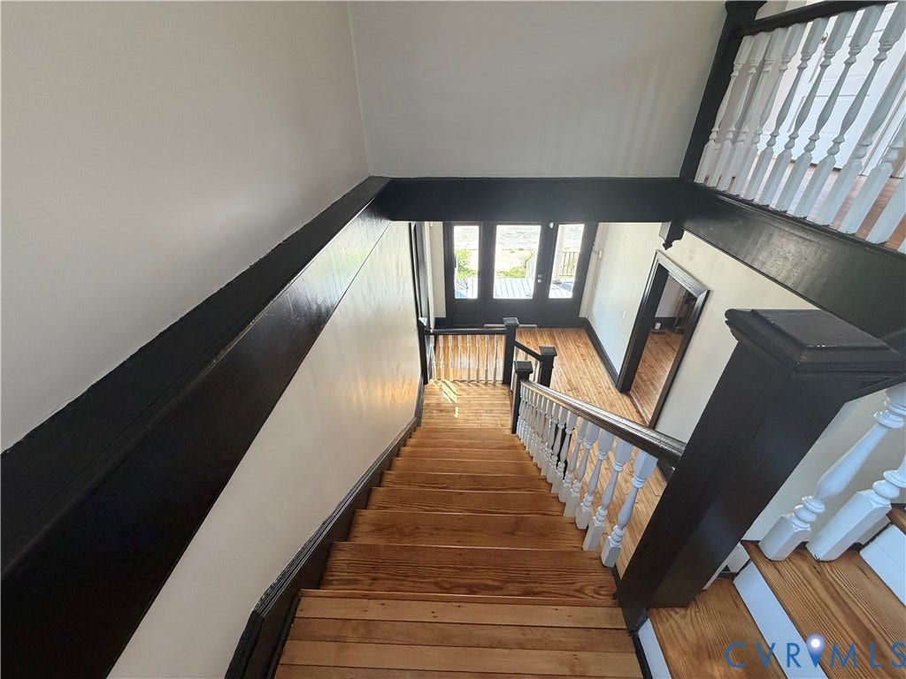715 High Street, Petersburg, VA 23803 Hardwood staircase and landing with white balusters and dark wood handrails
