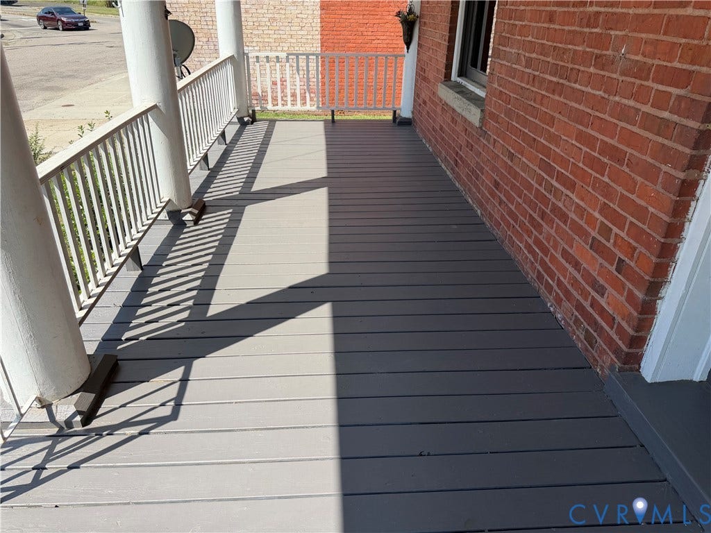 715 High Street, Petersburg, VA 23803 Expansive porch with plank flooring, white baluster railing, and brick exterior