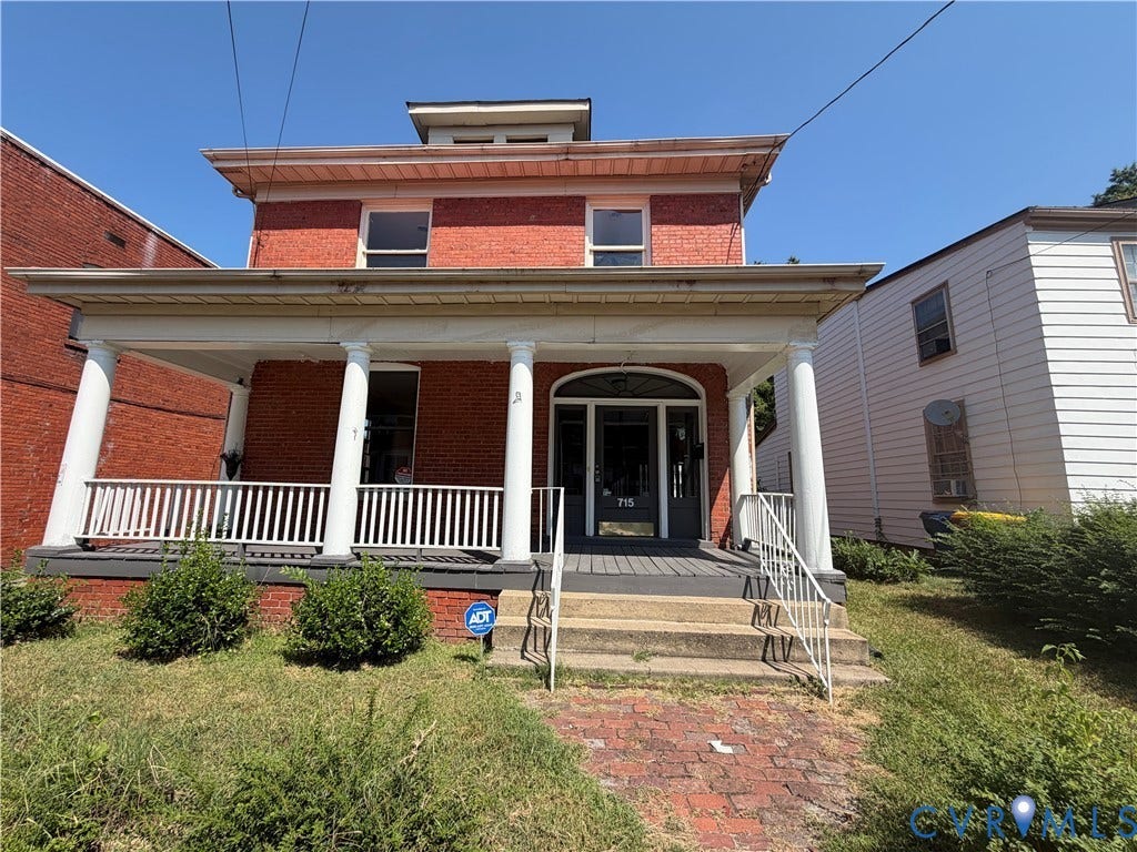 715 High Street, Petersburg, VA 23803 Red brick exterior with a columned porch, white railing, and multi-pane windows