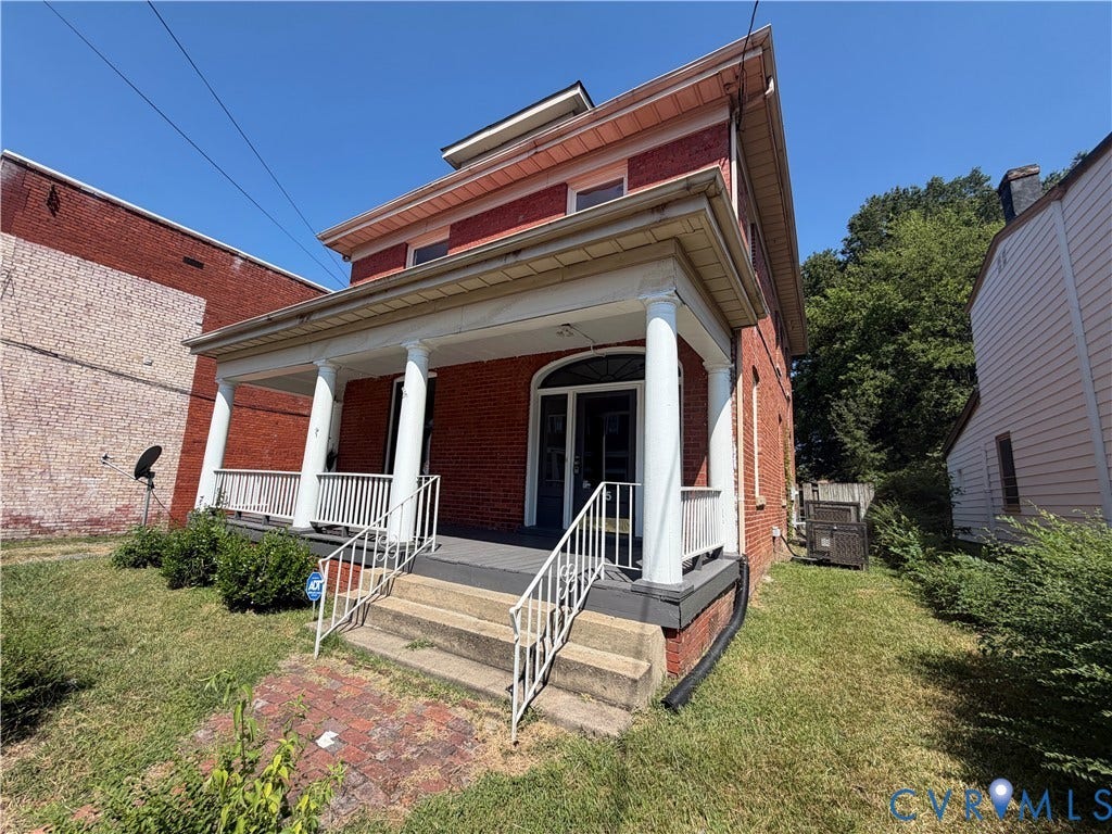 715 High Street, Petersburg, VA 23803 Brick exterior with a covered porch featuring white columns and railing