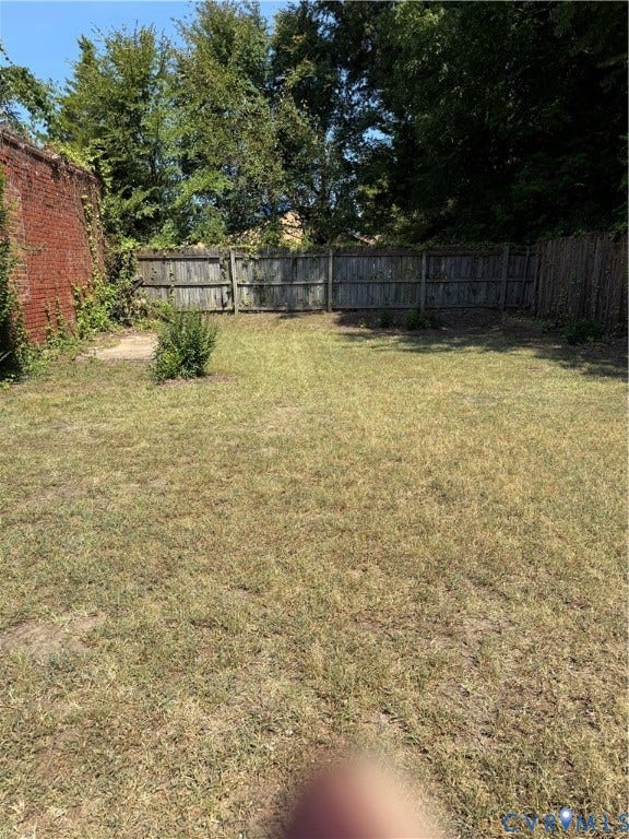 715 High Street, Petersburg, VA 23803 Expansive grassy area with wood fencing and a prominent brick wall