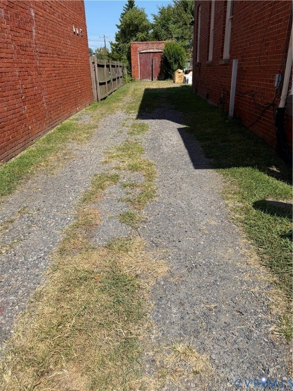715 High Street, Petersburg, VA 23803 Gravel drive with brick building exteriors and wood fencing
