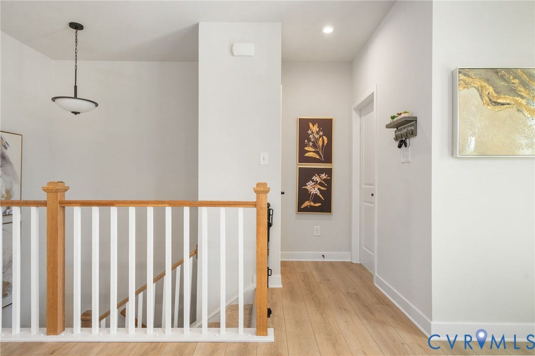 8045 Lake Laurel Lane, #B, Laurel Oak Condos, Glen Allen, VA 23060 Hardwood-finish flooring, white walls, and a staircase with natural wood newel posts and railings