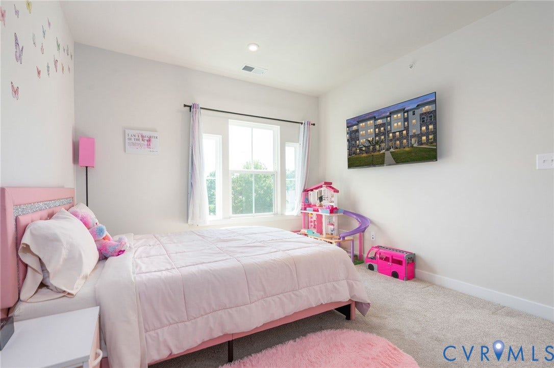 8045 Lake Laurel Lane, #B, Laurel Oak Condos, Glen Allen, VA 23060 Vaulted ceiling with recessed lighting, wall-mounted television, large window with outdoor greenery, and carpeted flooring