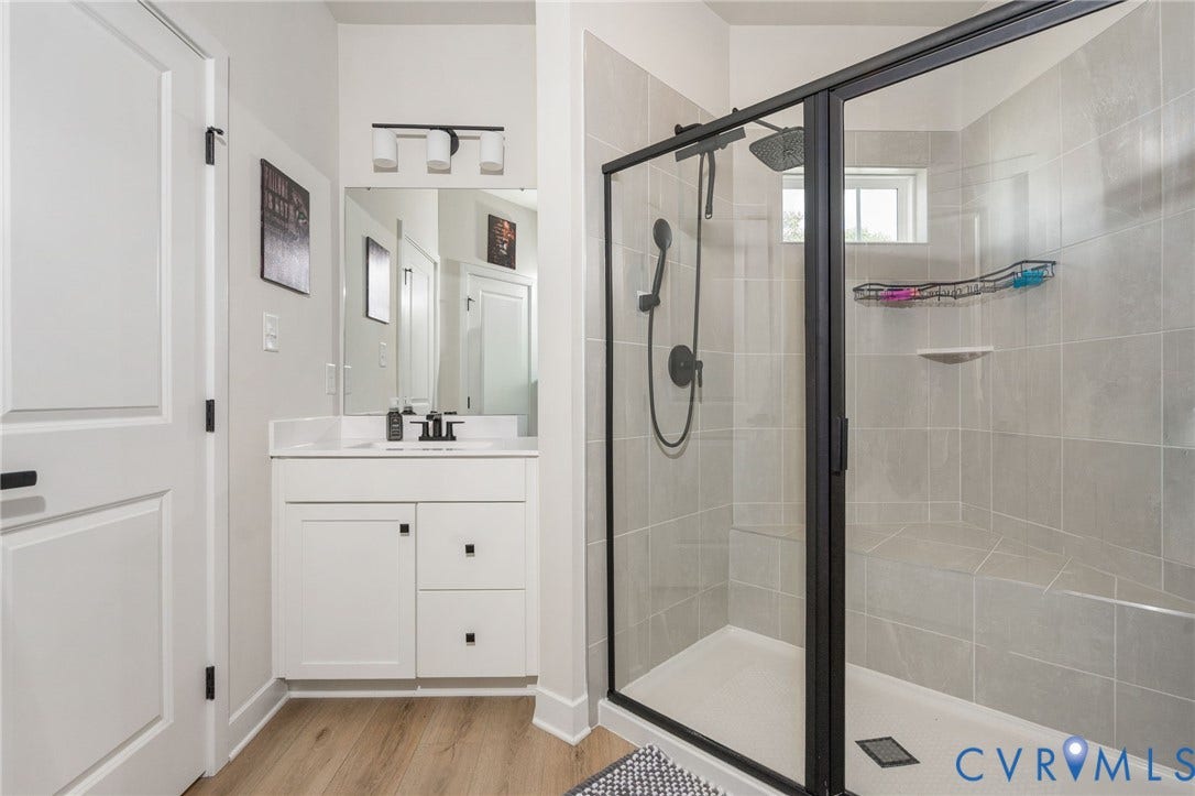 8045 Lake Laurel Lane, #B, Laurel Oak Condos, Glen Allen, VA 23060 Walk-in shower with clear glass enclosure and matte black hardware, tiled walls, built-in bench, and rain shower head