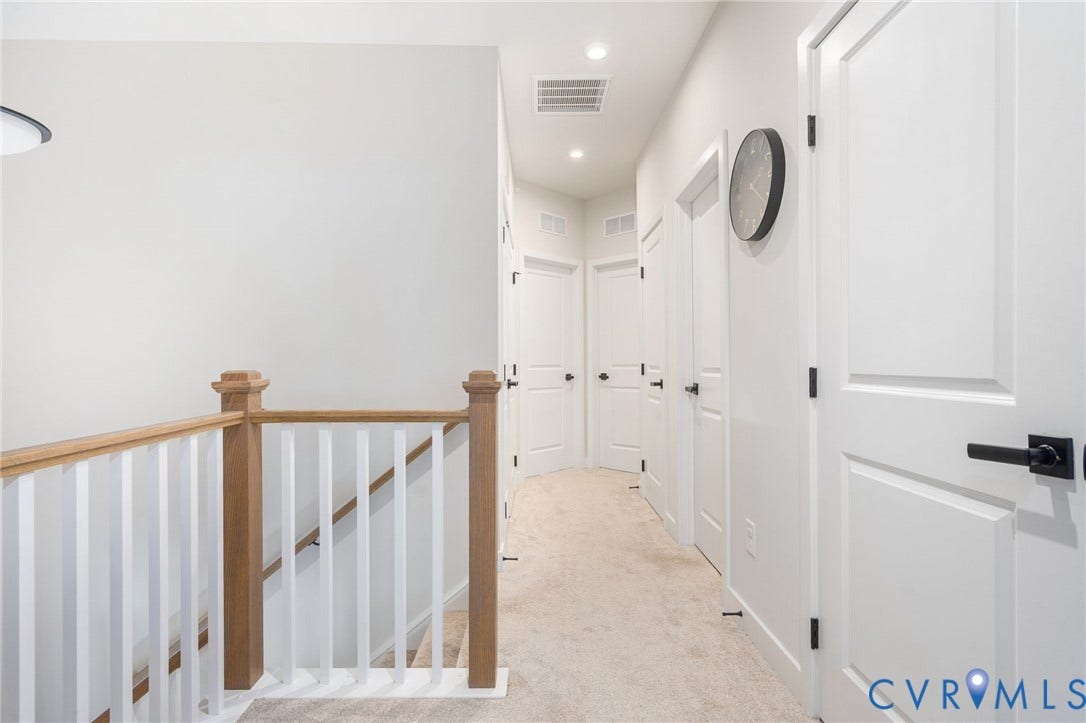 8045 Lake Laurel Lane, #B, Laurel Oak Condos, Glen Allen, VA 23060 Light-colored carpet flooring, white paneled doors with matte black hardware, recessed lighting, and a light-toned wooden banister with white balusters