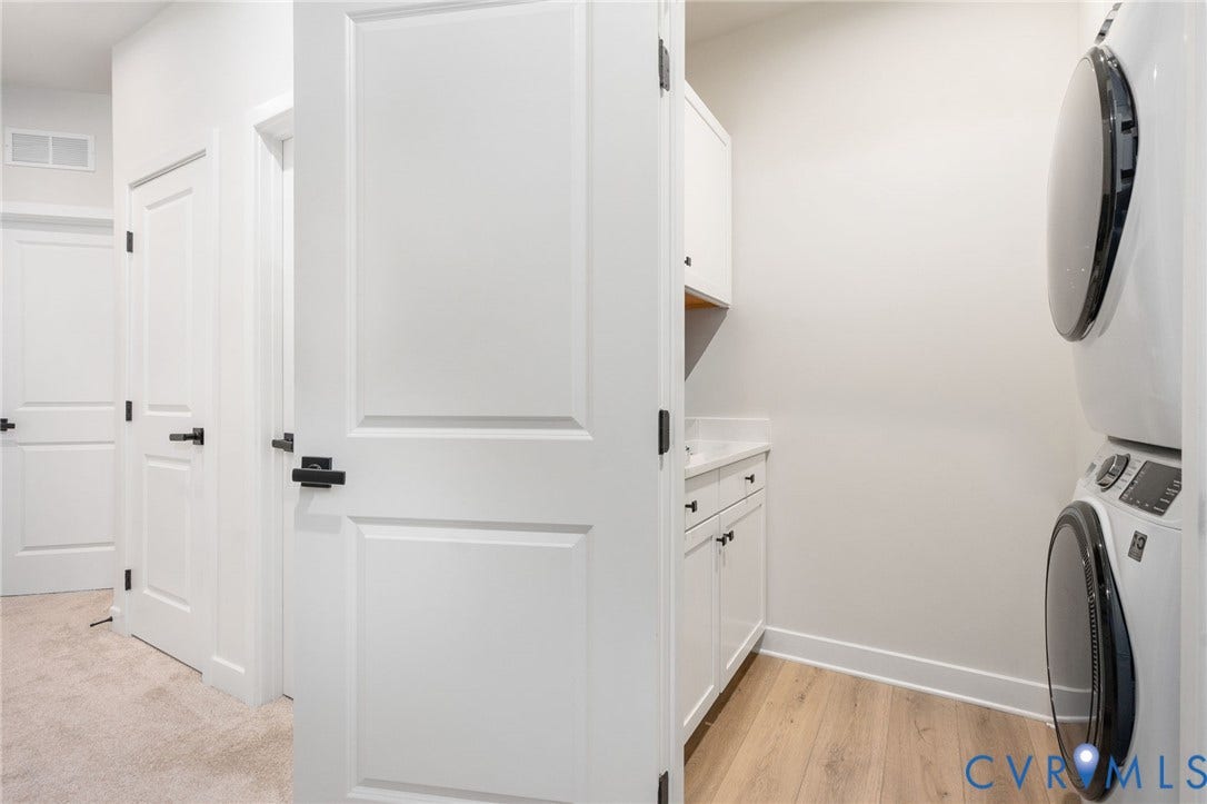 8045 Lake Laurel Lane, #B, Laurel Oak Condos, Glen Allen, VA 23060 Laundry area with stackable appliances, white cabinetry, a countertop, and wood-finish flooring