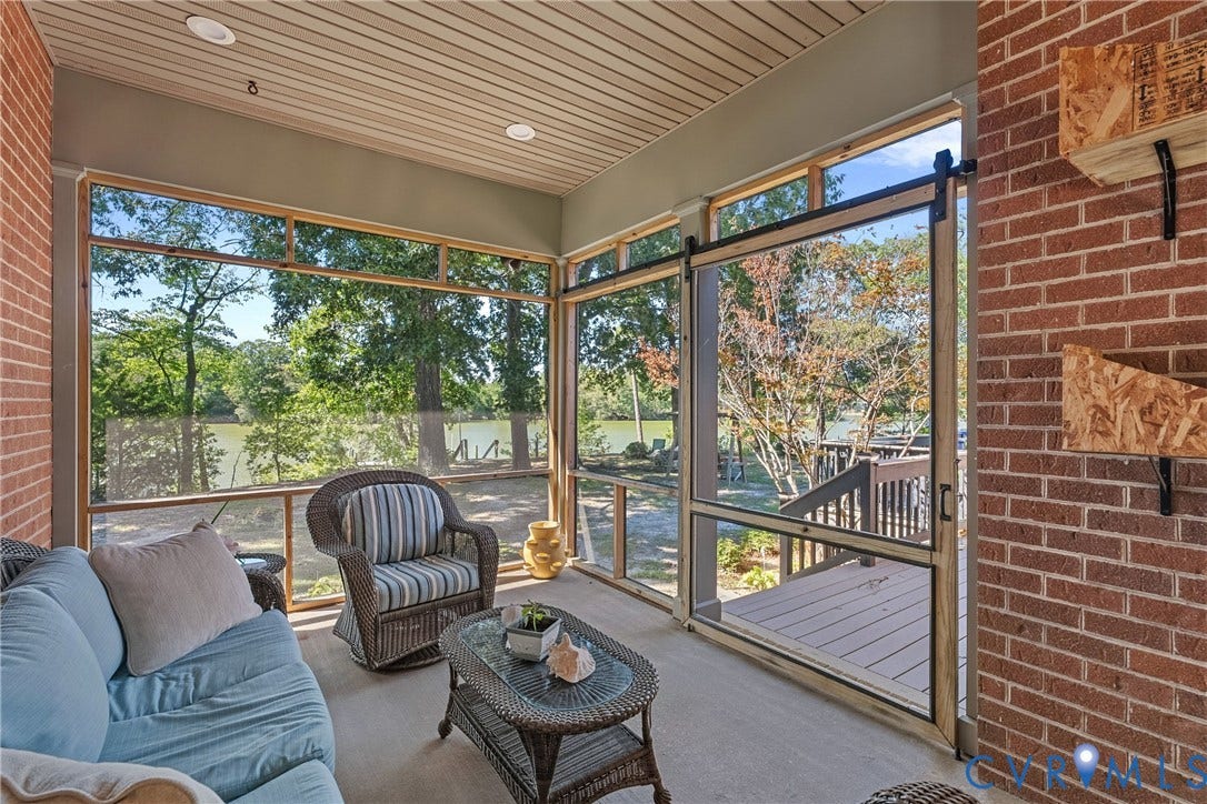 447 Tranquility Road, Reedville, VA 22539 Screened porch with brick wall, wood-finish ceiling, recessed lighting, and sliding screen door
