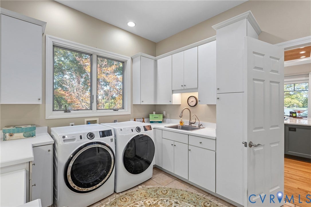 447 Tranquility Road, Reedville, VA 22539 Laundry area with built-in white cabinetry, light-toned countertops, a stainless steel sink with a gooseneck faucet, and a large window