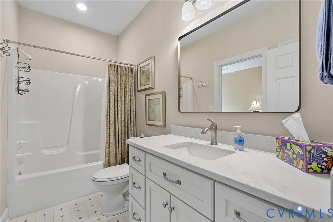447 Tranquility Road, Reedville, VA 22539 White vanity with brushed nickel hardware, integrated sink, and light-toned countertop