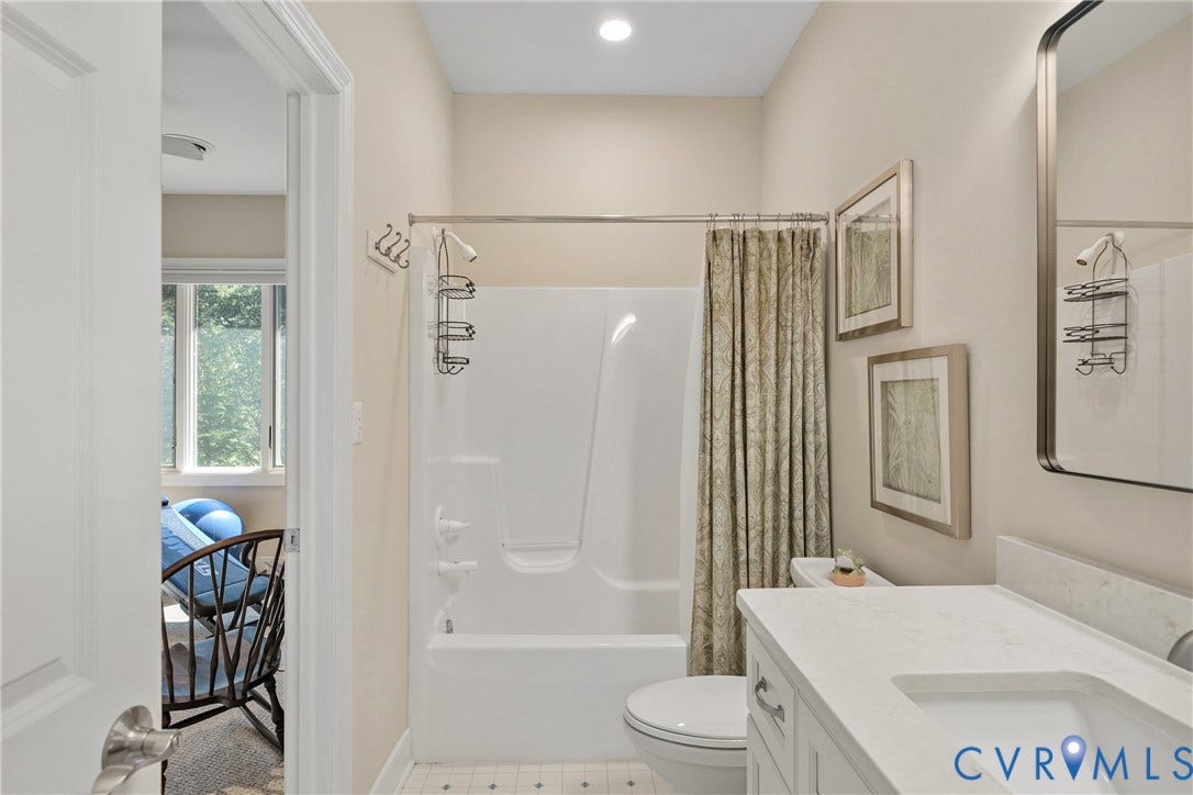447 Tranquility Road, Reedville, VA 22539 Full bathroom with a single vanity, a built-in tub and shower combination, and a recessed light fixture