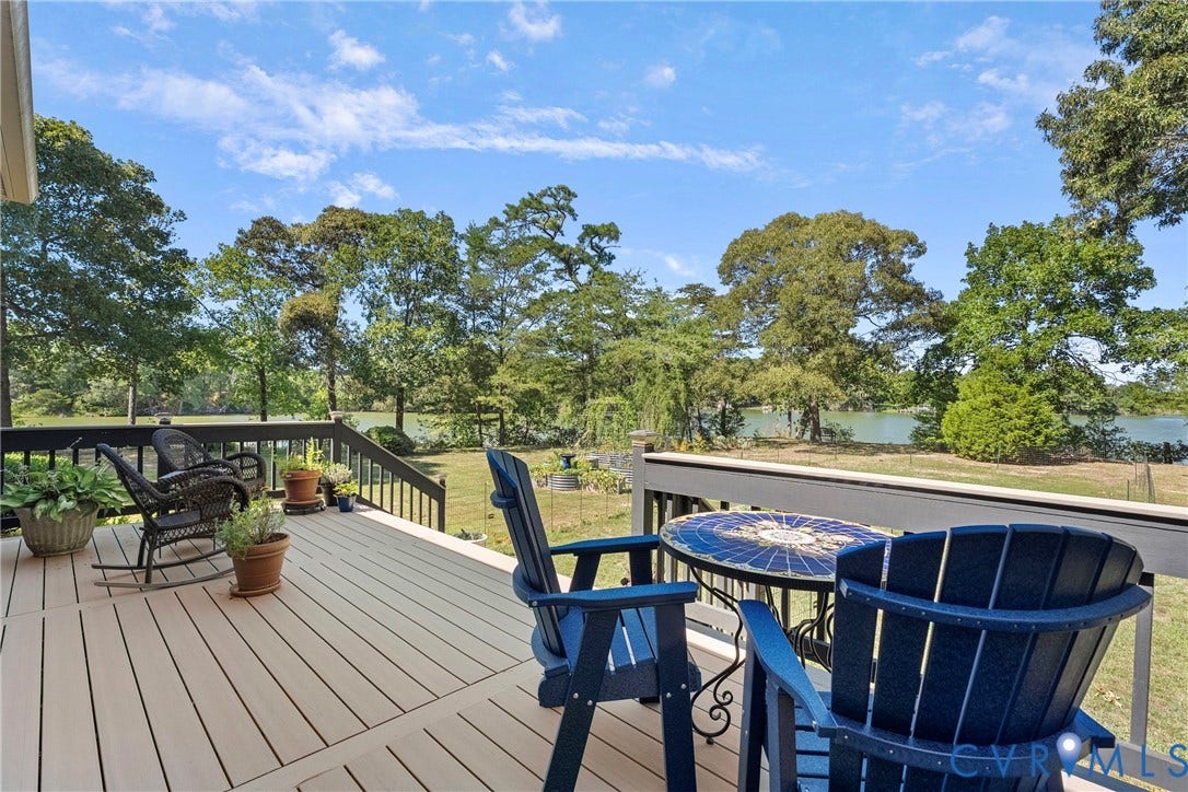 447 Tranquility Road, Reedville, VA 22539 Spacious outdoor deck with composite decking, dark wood railings, and expansive water frontage