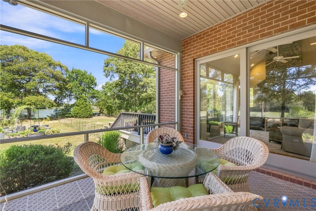 447 Tranquility Road, Reedville, VA 22539 Screened patio with brick wall and sliding glass door