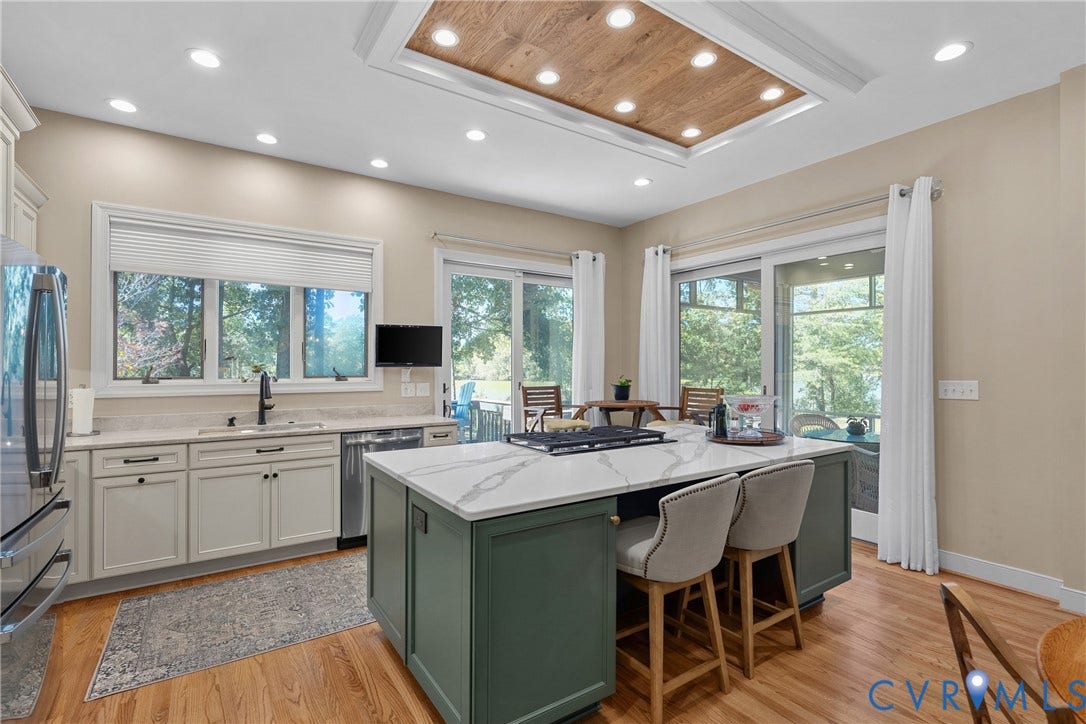447 Tranquility Road, Reedville, VA 22539 Kitchen featuring a central island with a cooktop, stone countertops, recessed lighting, wood-finish flooring, and sliding glass doors