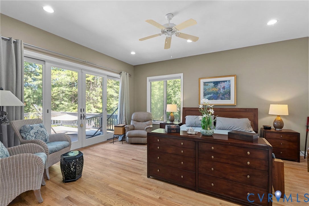 447 Tranquility Road, Reedville, VA 22539 Hardwood flooring, recessed lighting, ceiling fan, and sliding glass doors opening to an outdoor deck