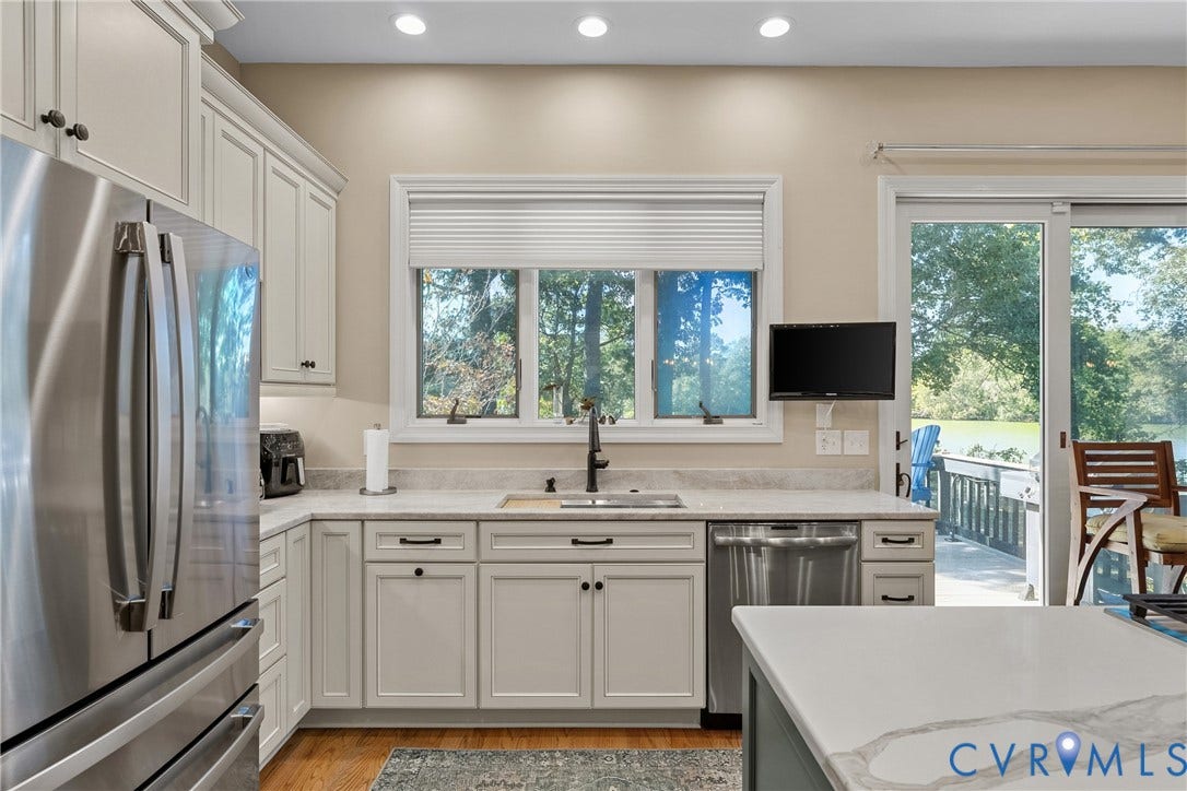 447 Tranquility Road, Reedville, VA 22539 Kitchen featuring light-toned cabinetry, stainless steel appliances, recessed lighting, a built-in sink, and granite countertops