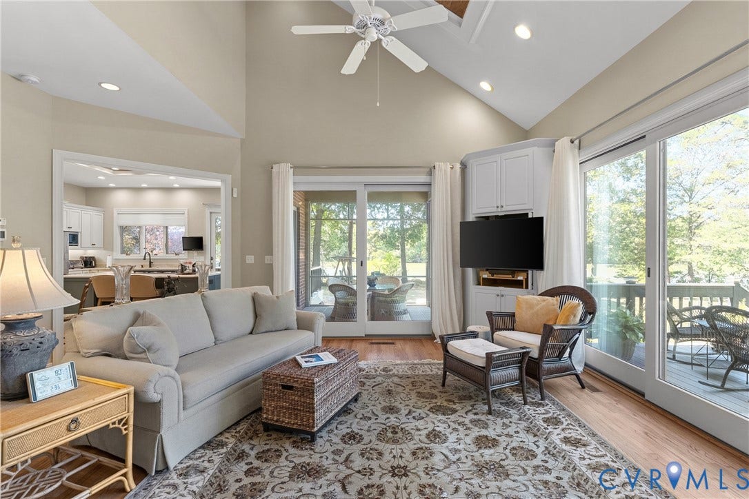 447 Tranquility Road, Reedville, VA 22539 Vaulted ceiling with a ceiling fan, recessed lighting, wood-finish flooring, built-in cabinetry, and sliding glass doors leading to an exterior deck