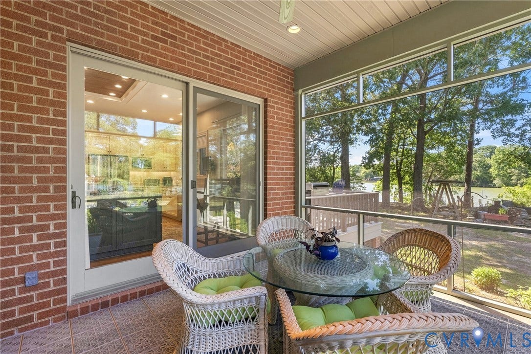 447 Tranquility Road, Reedville, VA 22539 Screened-in porch with a tile floor, brick exterior, and a sliding glass door