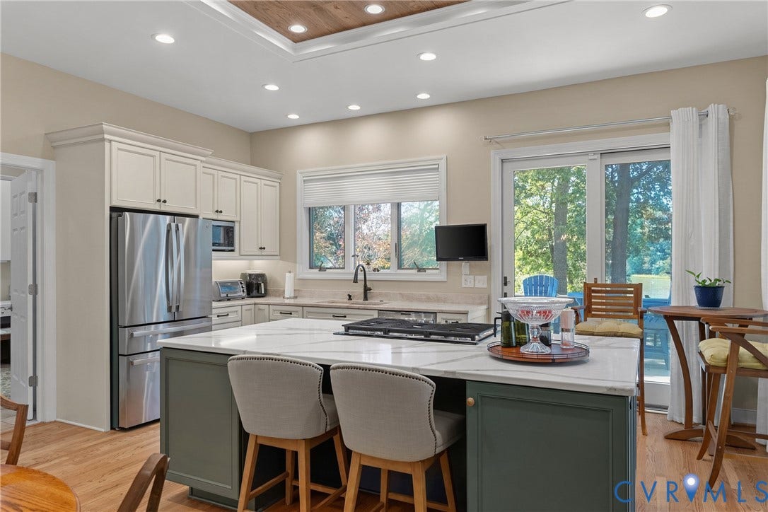 447 Tranquility Road, Reedville, VA 22539 Kitchen featuring stainless steel appliances, white cabinetry, a center island with a white countertop, recessed lighting, and wood-finish flooring