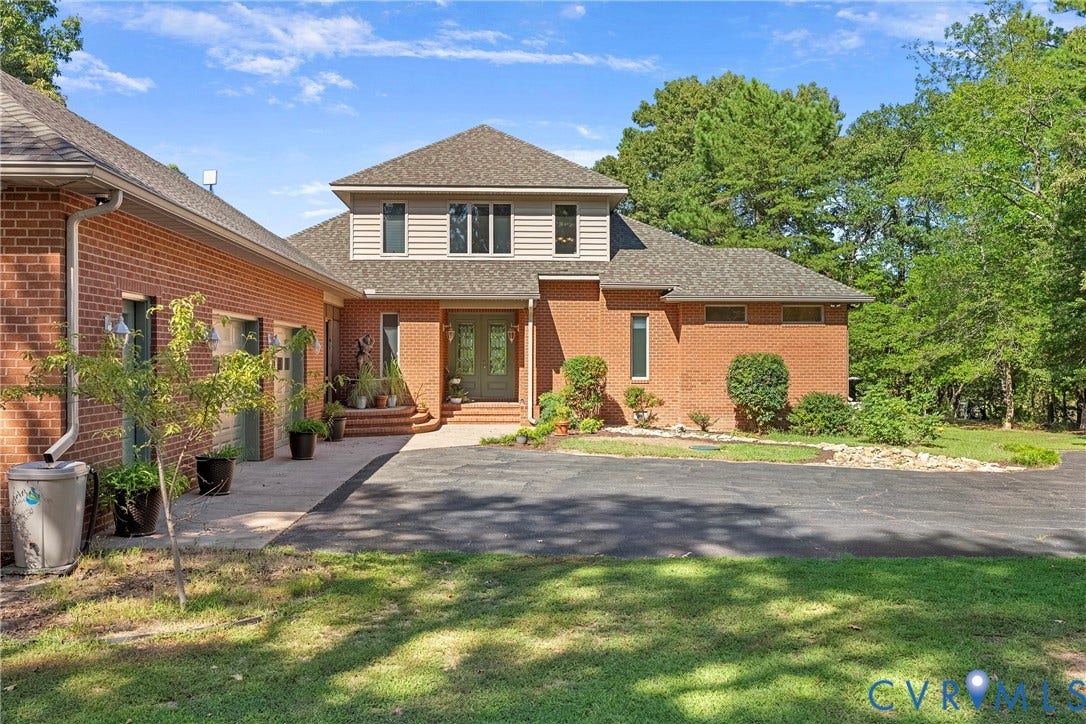 447 Tranquility Road, Reedville, VA 22539 Brick exterior with an asphalt driveway, concrete walkway, and attached two-car garage