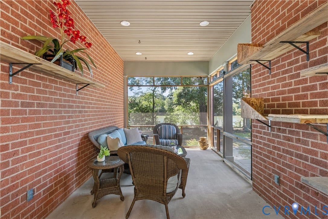 447 Tranquility Road, Reedville, VA 22539 Screened porch featuring brick walls, recessed lighting, and built-in shelving