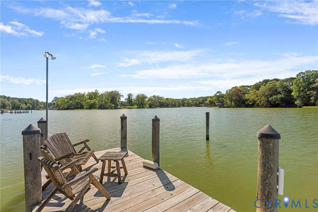 447 Tranquility Road, Reedville, VA 22539 Waterfront property featuring a wood-plank dock, piling posts, and a dual-head dock light