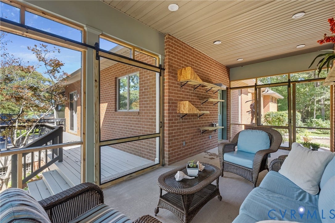 447 Tranquility Road, Reedville, VA 22539 Screened porch with brick wall, recessed lighting, concrete flooring, and sliding screen door
