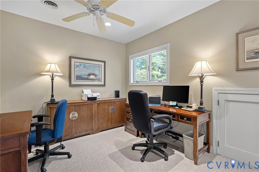 447 Tranquility Road, Reedville, VA 22539 Light-colored wall paint, white trim window, light-toned carpet flooring, ceiling fan with light fixture, and panel door