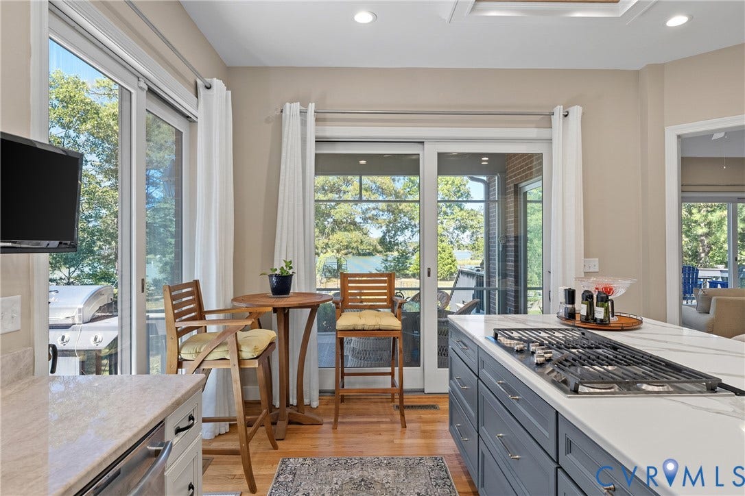447 Tranquility Road, Reedville, VA 22539 Gourmet kitchen with a built-in gas range, large center island with a stone countertop, and wood-finish flooring