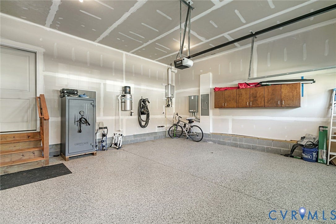 8681 Terroir Lane, Cottages At Viniterra, New Kent, VA 23124 Epoxy flooring, wood-finish wall cabinets, and built-in garage door opener