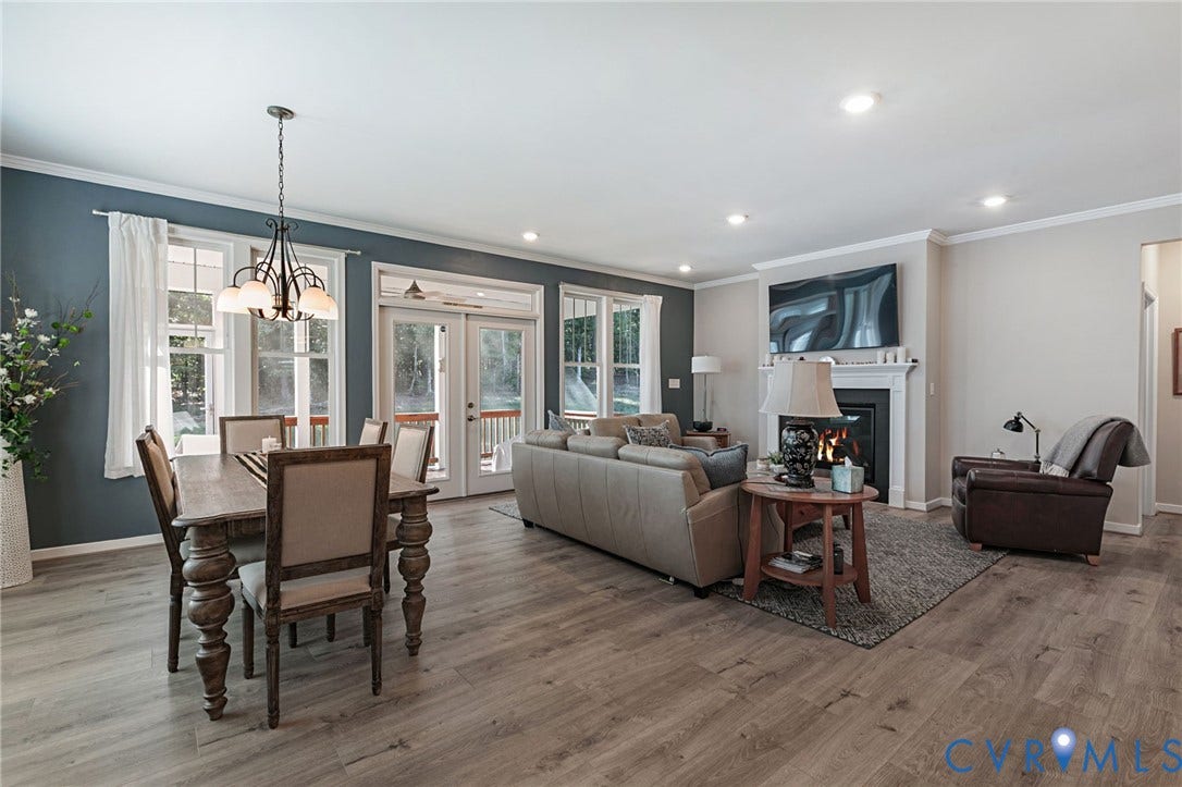 8681 Terroir Lane, Cottages At Viniterra, New Kent, VA 23124 Open-concept living area featuring LVP flooring and a fireplace with a white mantel