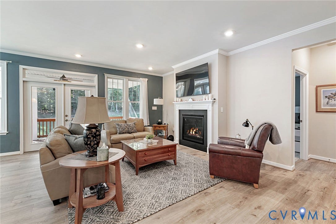 8681 Terroir Lane, Cottages At Viniterra, New Kent, VA 23124 Recessed lighting, crown molding, LVP flooring, white mantel, and glass-paneled doors to screened in porch