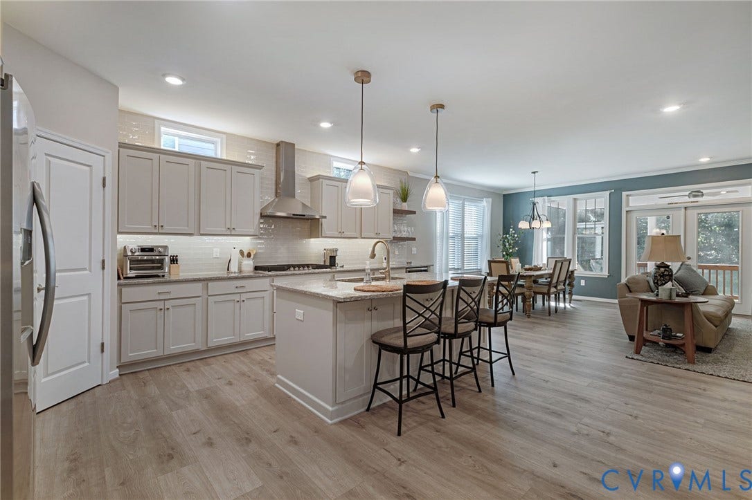 8681 Terroir Lane, Cottages At Viniterra, New Kent, VA 23124 Open-concept living space featuring LVP flooring, recessed lighting, and a kitchen with light-toned cabinetry
