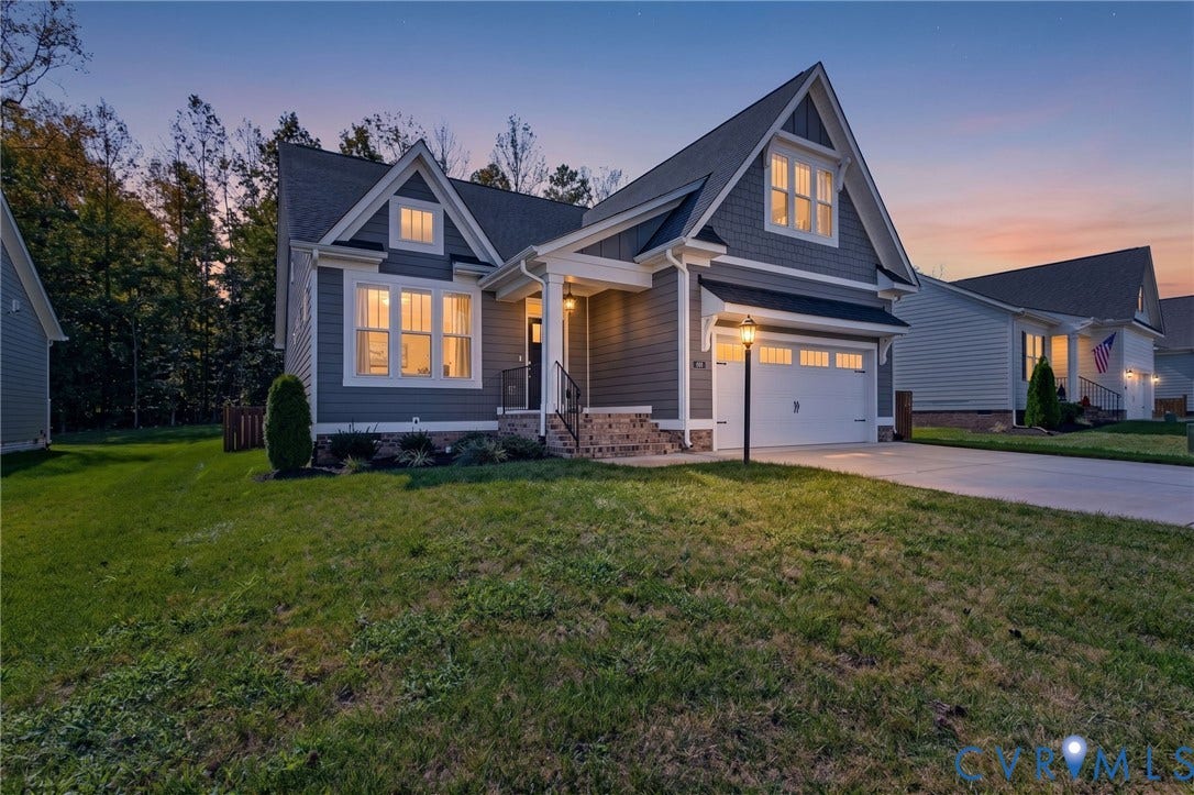 8681 Terroir Lane, Cottages At Viniterra, New Kent, VA 23124 Gray hardi plank siding exterior with white trim, covered front porch, attached garage with carriage-style door, and a concrete driveway