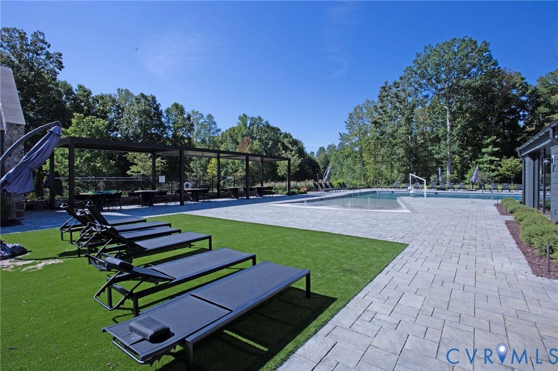 8681 Terroir Lane, Cottages At Viniterra, New Kent, VA 23124 In-ground swimming pool with an expansive paver patio, artificial turf, and a shaded pergola area